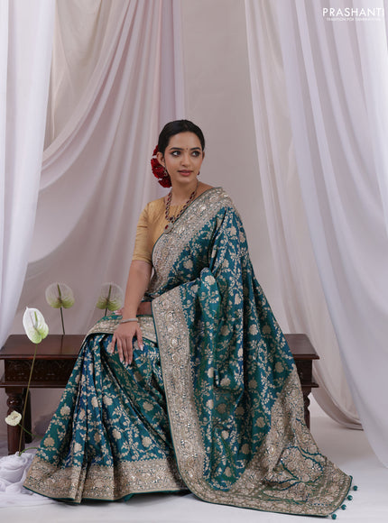 Teal Blue Banarasi Uppada silk saree with allover zari weaves & embroidery border