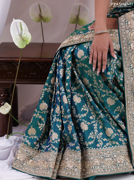 Teal Blue Banarasi Uppada silk saree with allover zari weaves & embroidery border