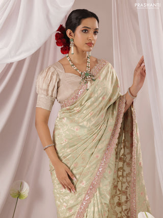 Pastel Green-Peach Pink Banarasi Uppada silk saree with allover zari weaves & embroidery border