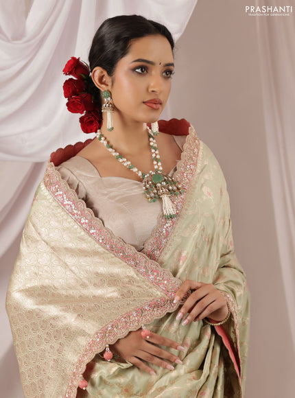Pastel Green-Peach Pink Banarasi Uppada silk saree with allover zari weaves & embroidery border