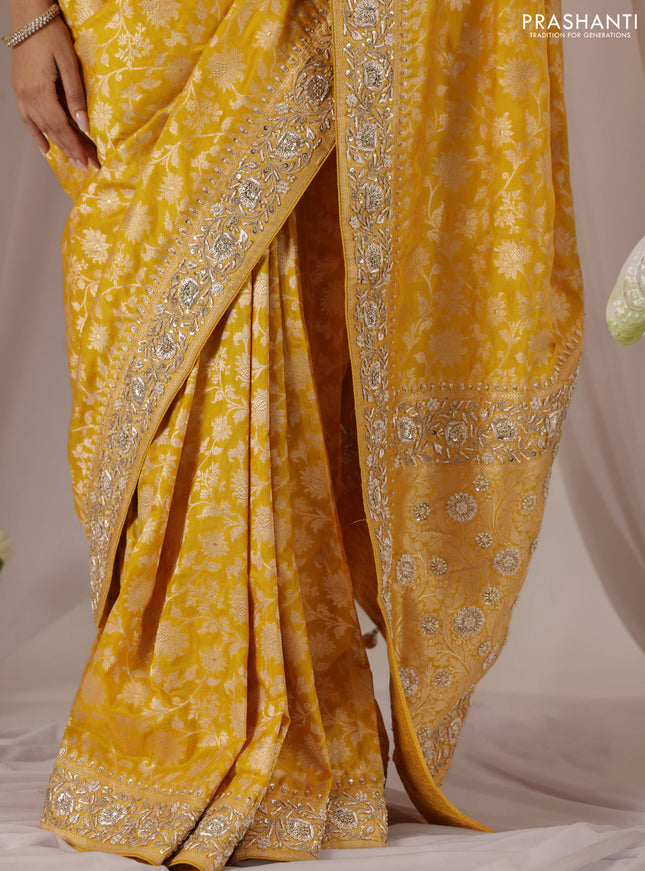 Mango yellow Banarasi Uppada silk saree with allover zari weaves & embroidery border