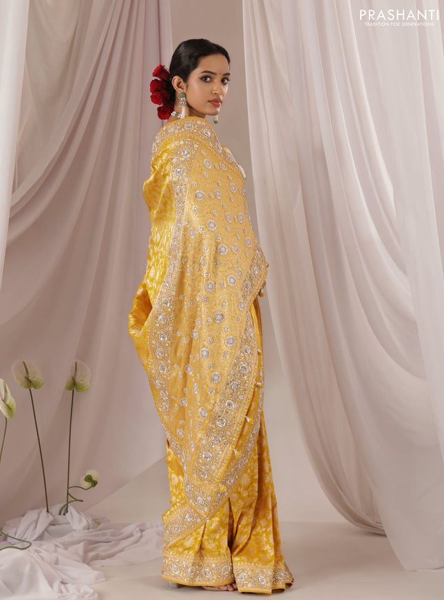 Mango yellow Banarasi Uppada silk saree with allover zari weaves & embroidery border