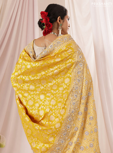 Mango yellow Banarasi Uppada silk saree with allover zari weaves & embroidery border