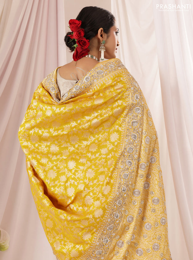 Mango yellow Banarasi Uppada silk saree with allover zari weaves & embroidery border