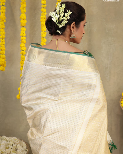 Cream-Green Pure kanchipuram silk saree with silver & gold zari woven stripes pattern and long zari woven border