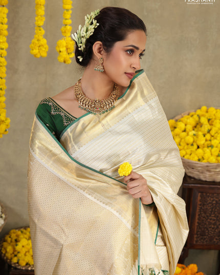 Cream-Green Pure kanchipuram silk saree with silver & gold zari woven stripes pattern and long zari woven border
