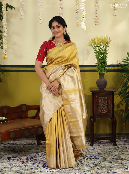 Gold Tissue kanchipuram silk saree with zari woven brocade weaves & rising temple border