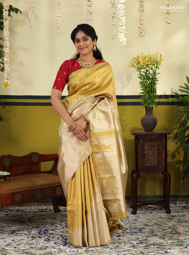 Gold Tissue kanchipuram silk saree with zari woven brocade weaves & rising temple border
