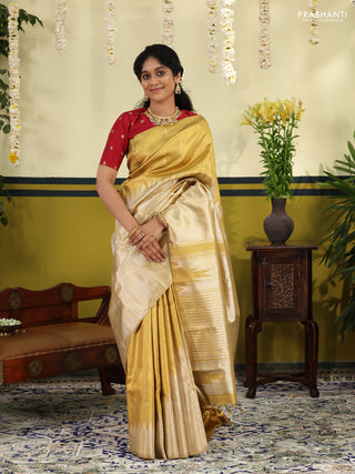 Gold Tissue kanchipuram silk saree with zari woven brocade weaves & rising temple border