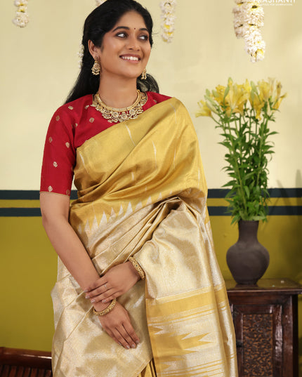 Gold Tissue kanchipuram silk saree with zari woven brocade weaves & rising temple border