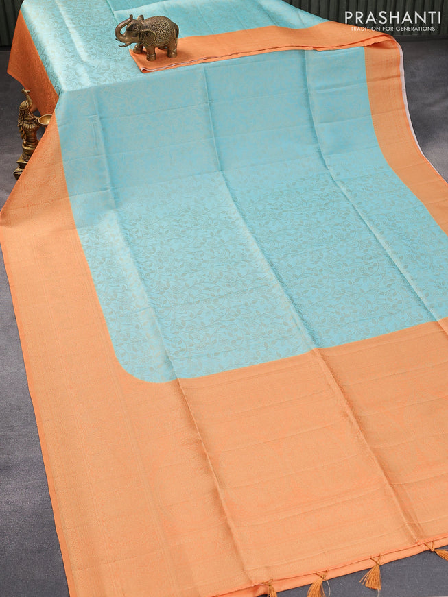 Banarasi softy silk saree light blue and pale orange with allover silver zari woven brocade weaves and silver zari woven border