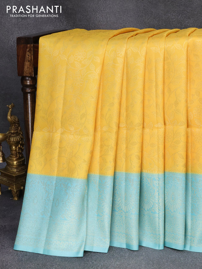 Banarasi softy silk saree yellow and light blue with allover silver zari woven brocade weaves and silver zari woven border
