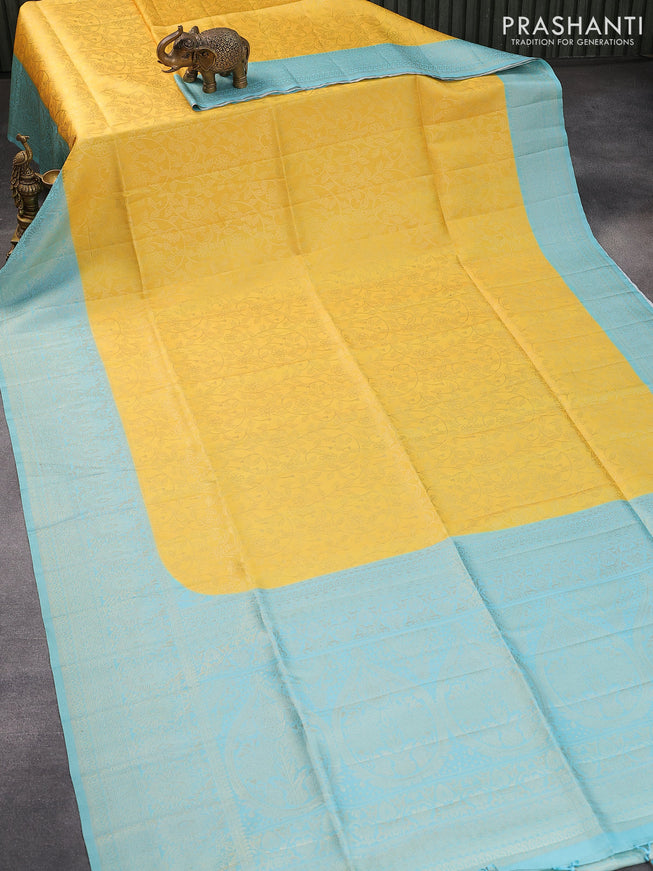 Banarasi softy silk saree yellow and light blue with allover silver zari woven brocade weaves and silver zari woven border