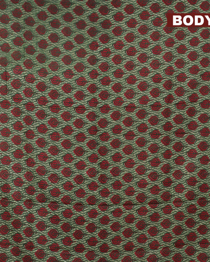 Mul cotton saree green shade with allover leaf butta prints and small zari woven border