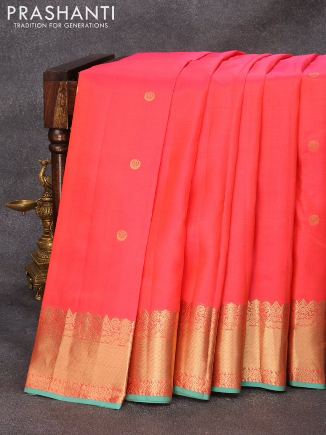 Pure kanjivaram silk saree dual shade of pinkish orange and teal shade with zari woven buttas and zari woven border & Butta style