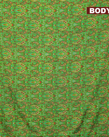 Semi crepe saree green and mustard yellow with allover paisley prints and zari woven border