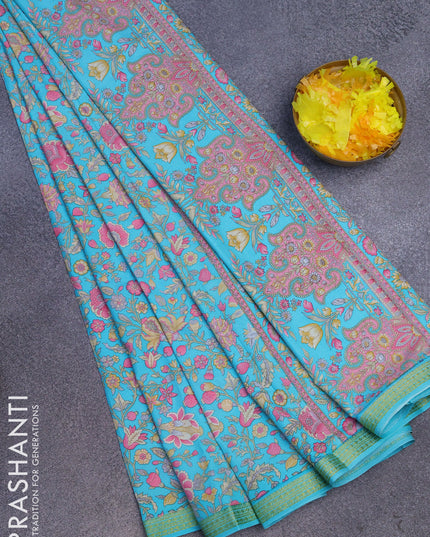 Semi crepe saree teal blue with allover prints and zari woven border
