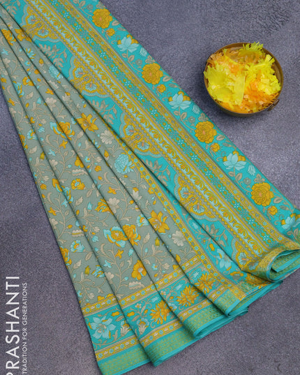 Semi crepe saree pastel green and teal green with floral prints and zari woven border