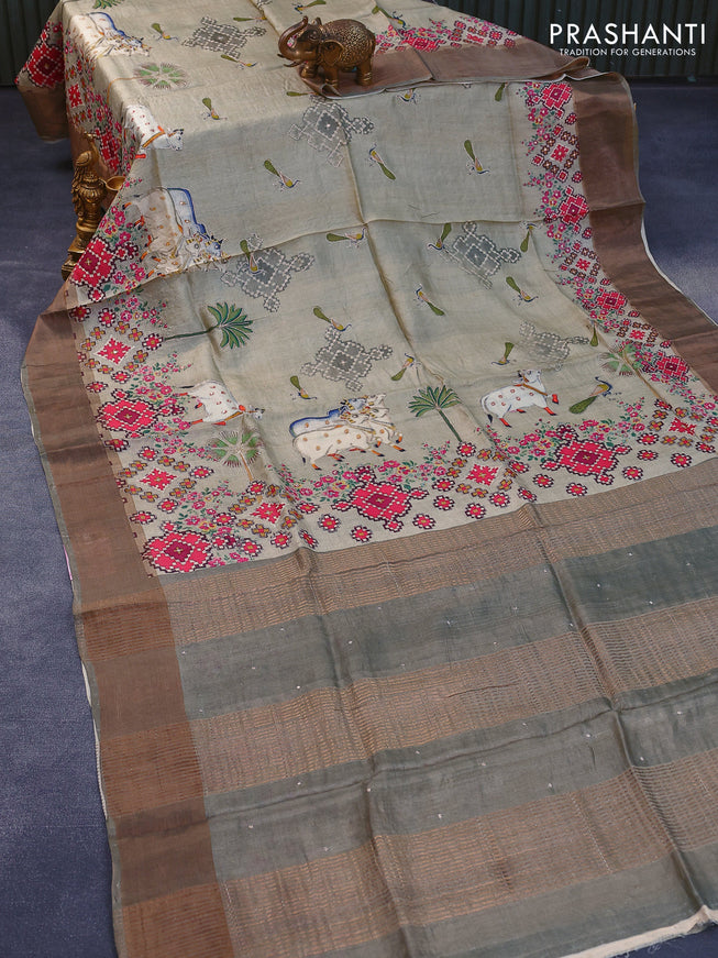 Pure tussar silk saree elaichi green and greyish green with allover pichwai prints & embroidery work and zari woven border