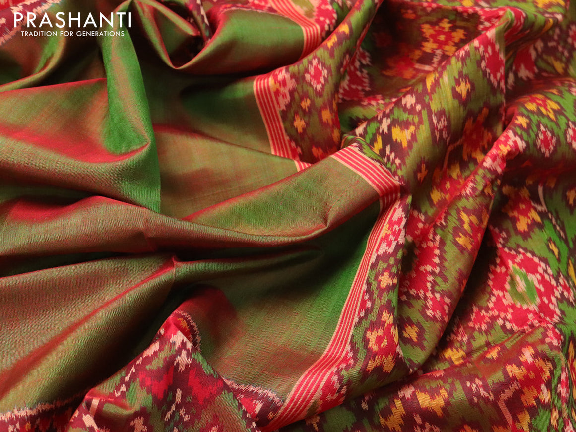Rajkot patola silk saree dual shade of reddish green and red with plain body and long ikat woven zari woven border