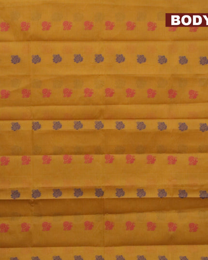 Nithyam cotton saree mustard yellow and pink with allover thread woven buttas and zari woven simple border