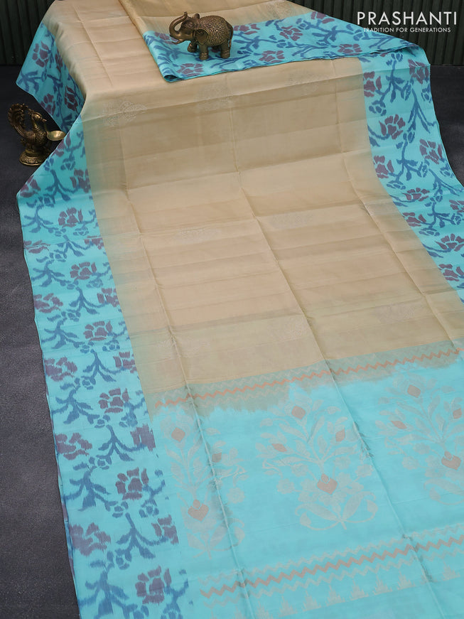 Ikat soft silk saree beige and light blue with silver zari woven buttas and ikat style border
