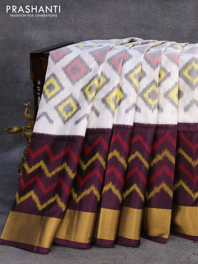 Ikat soft silk saree off white and deep jamun shade with ikat woven geometric butta weaves and zari woven border