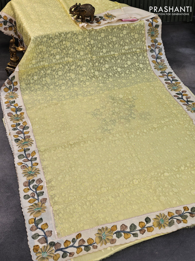 Pure organza silk saree pale yellow and cream with allover embroidery work and tussar kalamkari printed border