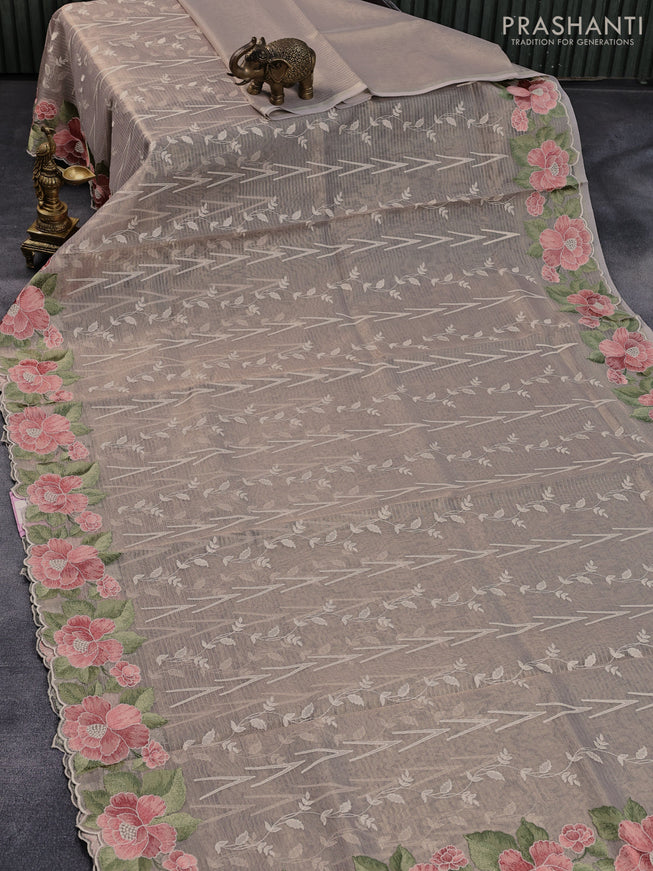 Tissue sarees beige with allover embroidery work and floral embroidery work border