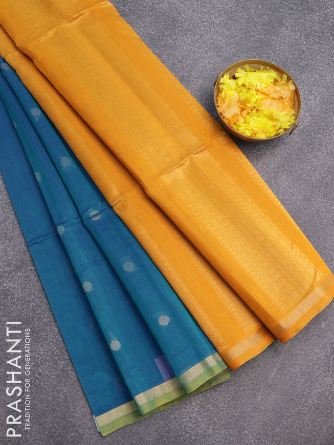 Kora silk cotton saree dual shade of bluish green and mustard yellow with zari woven floral buttas and zari woven border