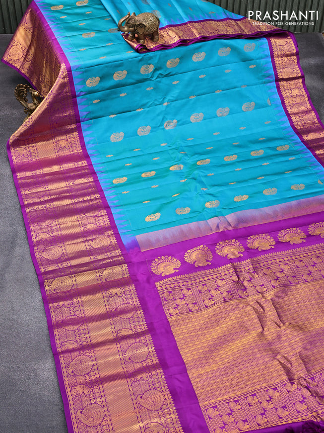 Pure gadwal silk saree dual shade of cs blue and purple with zari woven buttas and temple design long zari woven border