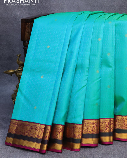 Pure kanjivaram silk saree dual shade of teal blue and purple with allover self emboss & zari buttas and annam zari woven korvai border