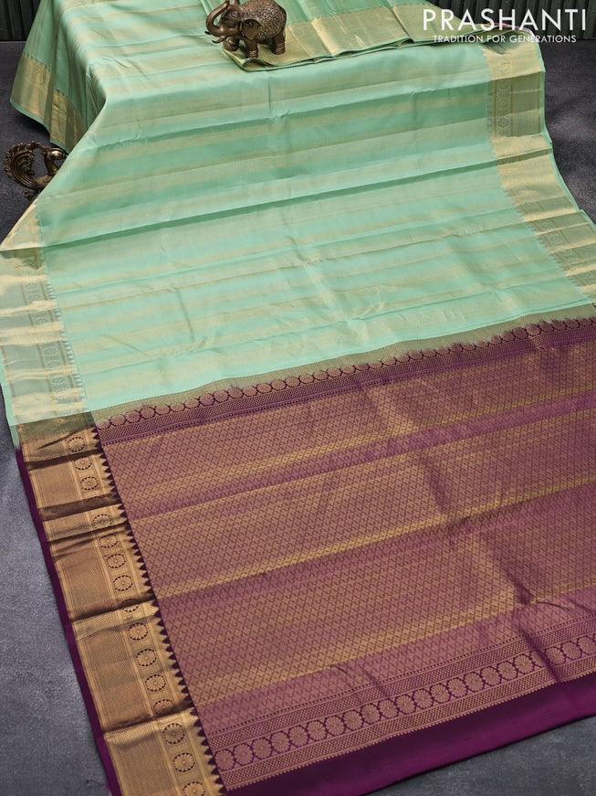 Pure kanjivaram silk saree pastel green and deep purple with allover zari weaves and zari woven border