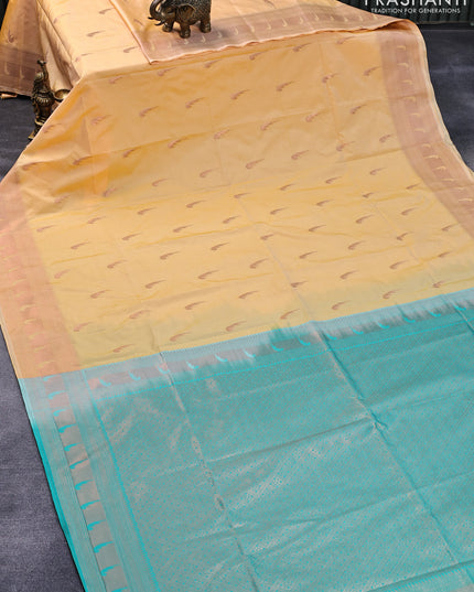 Semi soft silk saree yellow and teal blue with zari woven buttas and copper zari woven border
