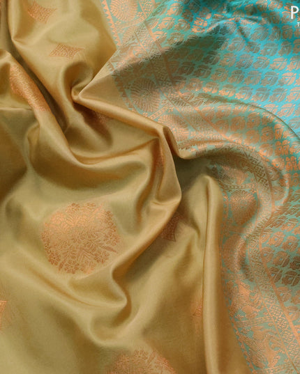 Semi soft silk saree sandal and teal green with copper zari woven buttas and copper zari woven border