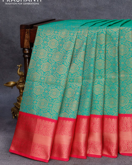 Semi soft silk saree teal green shade and pink with allover zari woven brocade weaves and paisley zari woven border