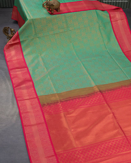 Semi soft silk saree teal green shade and pink with allover zari woven brocade weaves and paisley zari woven border