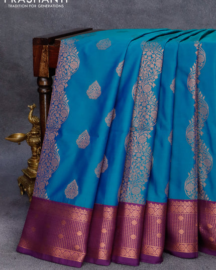 Semi soft silk saree dual shade of bluish green and purple with copper zari woven buttas and copper zari woven border
