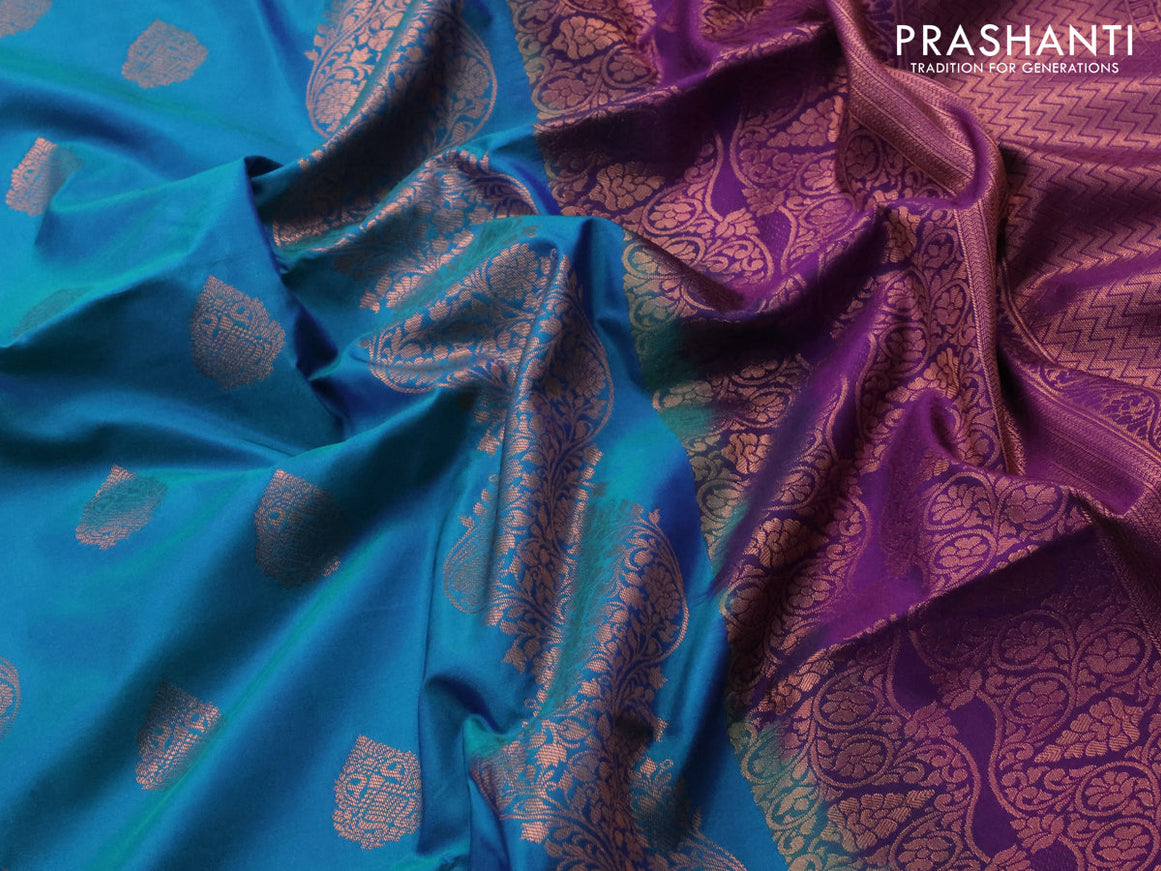 Semi soft silk saree dual shade of bluish green and purple with copper zari woven buttas and copper zari woven border