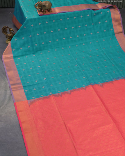 Semi soft silk saree blue and peach pink with allover self emboss & copper zari buttas and zari woven border