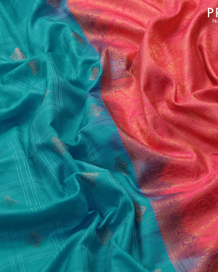 Semi soft silk saree blue and peach pink with allover self emboss & copper zari buttas and zari woven border