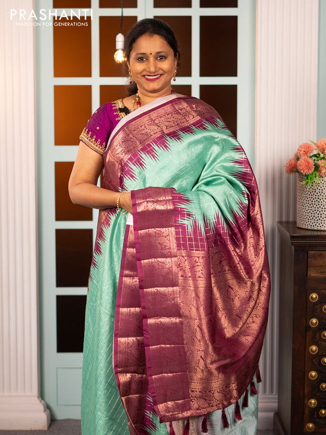 Semi raw silk saree teal blue shade and purple with allover zari checked pattern and temple design copper zari woven border