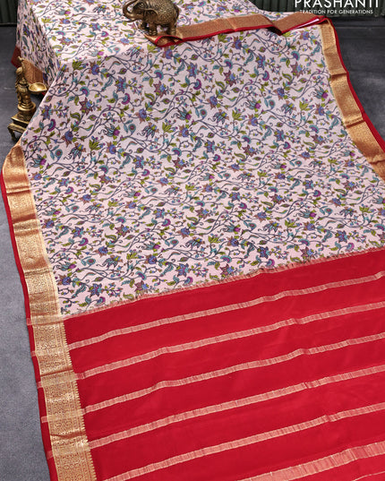 Printed crepe silk saree pastel peach shade and kum kum red with allover kalamkari prints and zari woven border