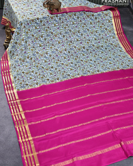 Printed crepe silk saree teal blue and pink with allover floral prints and zari woven border