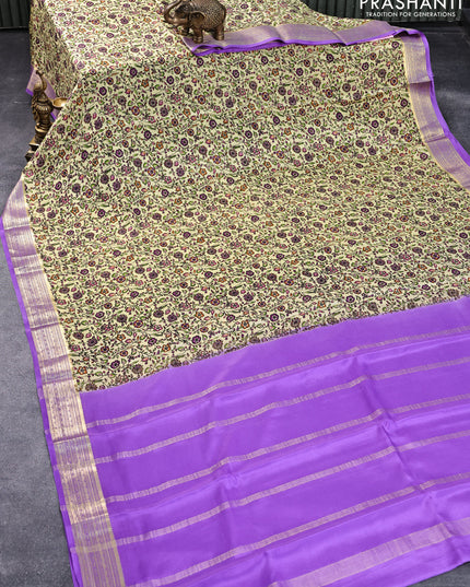 Printed crepe silk saree pale yellow and levender with allover floral prints and zari woven border
