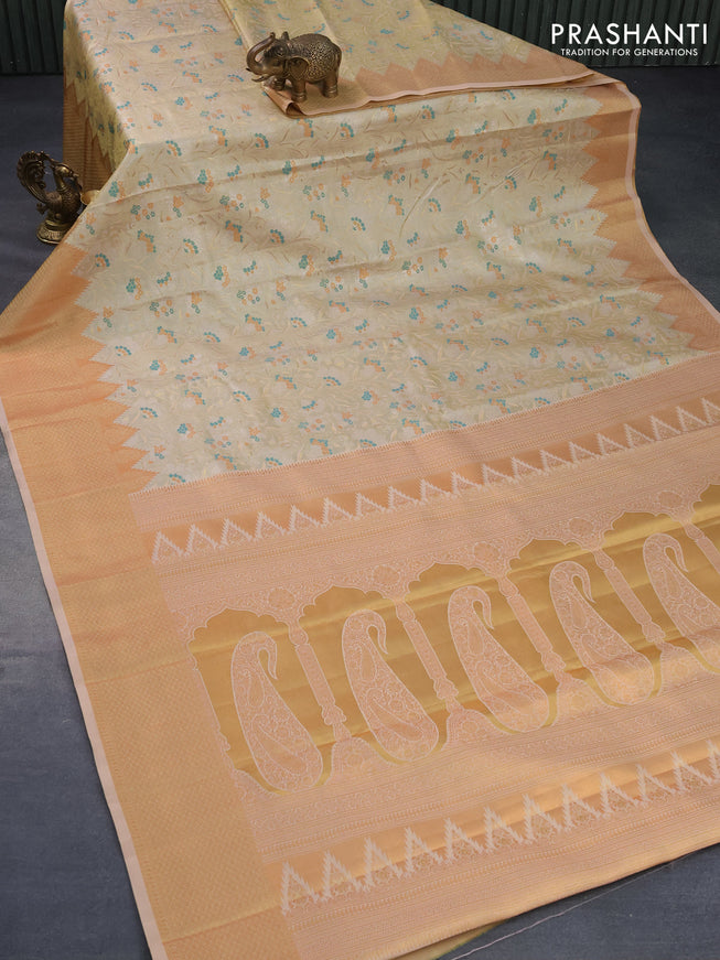 Tissue semi kanjivaram silk saree cream with allover zari woven brocade weaves and temple design copper zari woven border