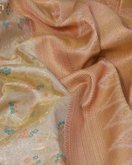 Tissue semi kanjivaram silk saree cream with allover zari woven brocade weaves and temple design copper zari woven border