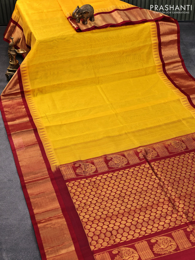 Kuppadam silk cotton saree mango yellow and maroon with plain body and temple design long zari woven border