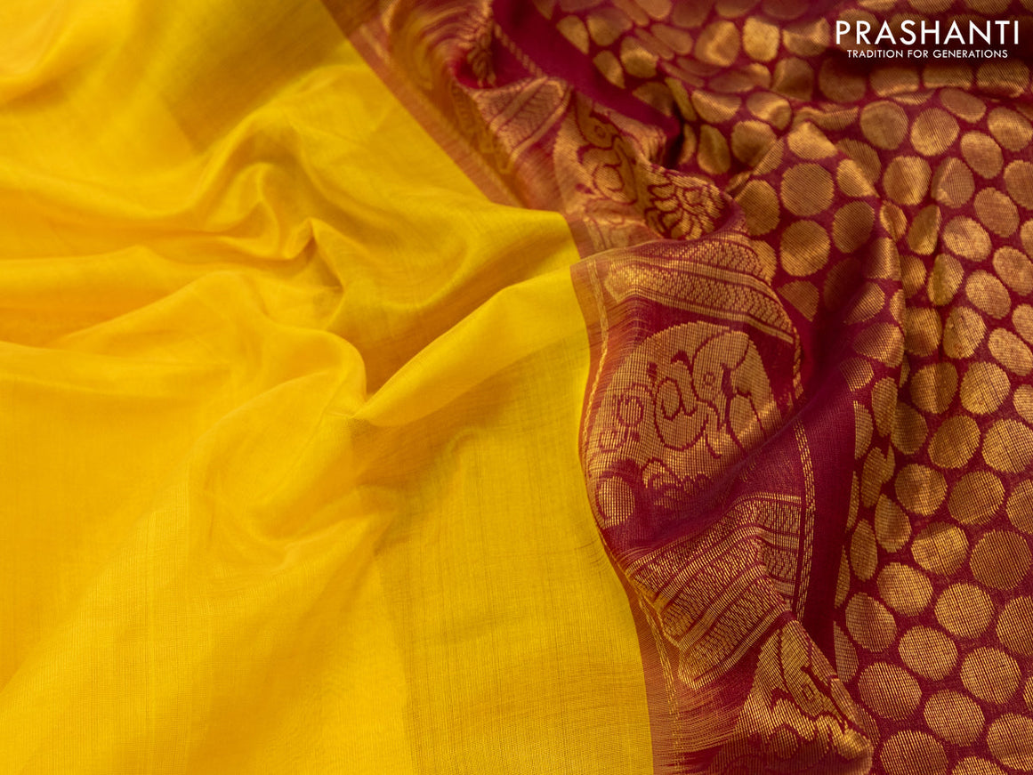 Kuppadam silk cotton saree mango yellow and maroon with plain body and temple design long zari woven border