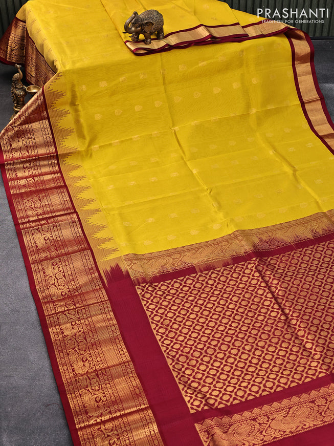 Kuppadam silk cotton saree mustard yellow and maroon with allover zari woven buttas and temple design long zari woven annam border